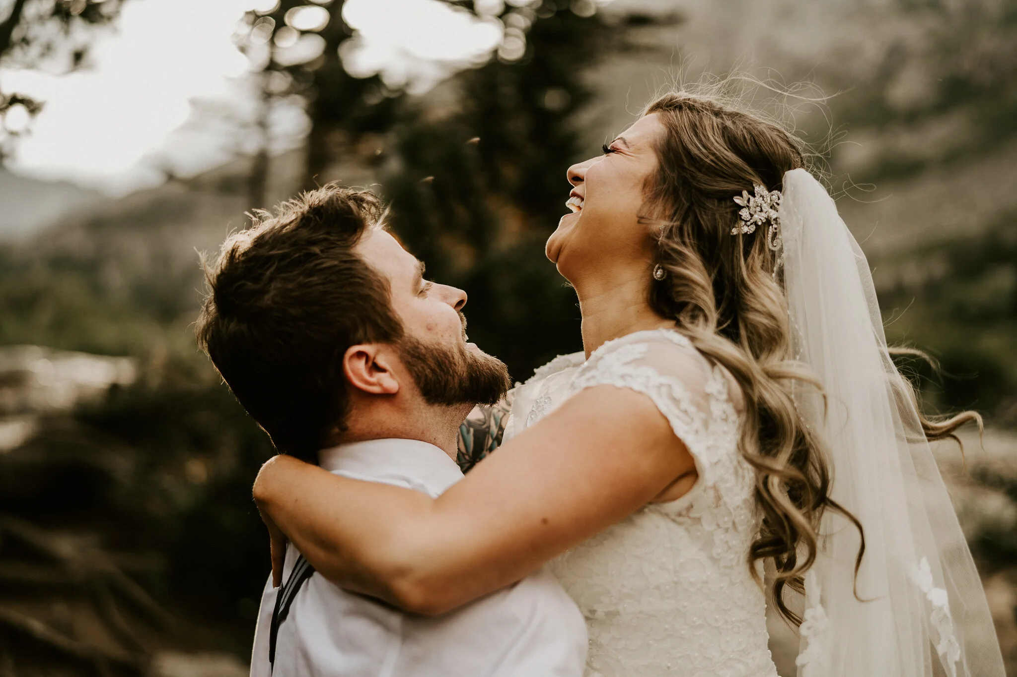 A bride & groom laugh together on their elopement day.
