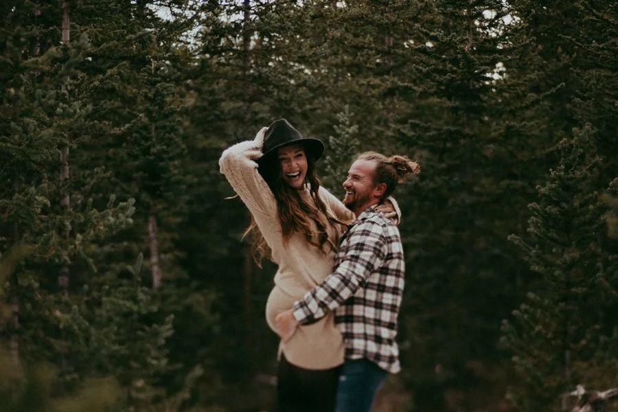 Owners of Summit Mountain Weddings in Breckenridge Colorado laugh & smile at the camera.