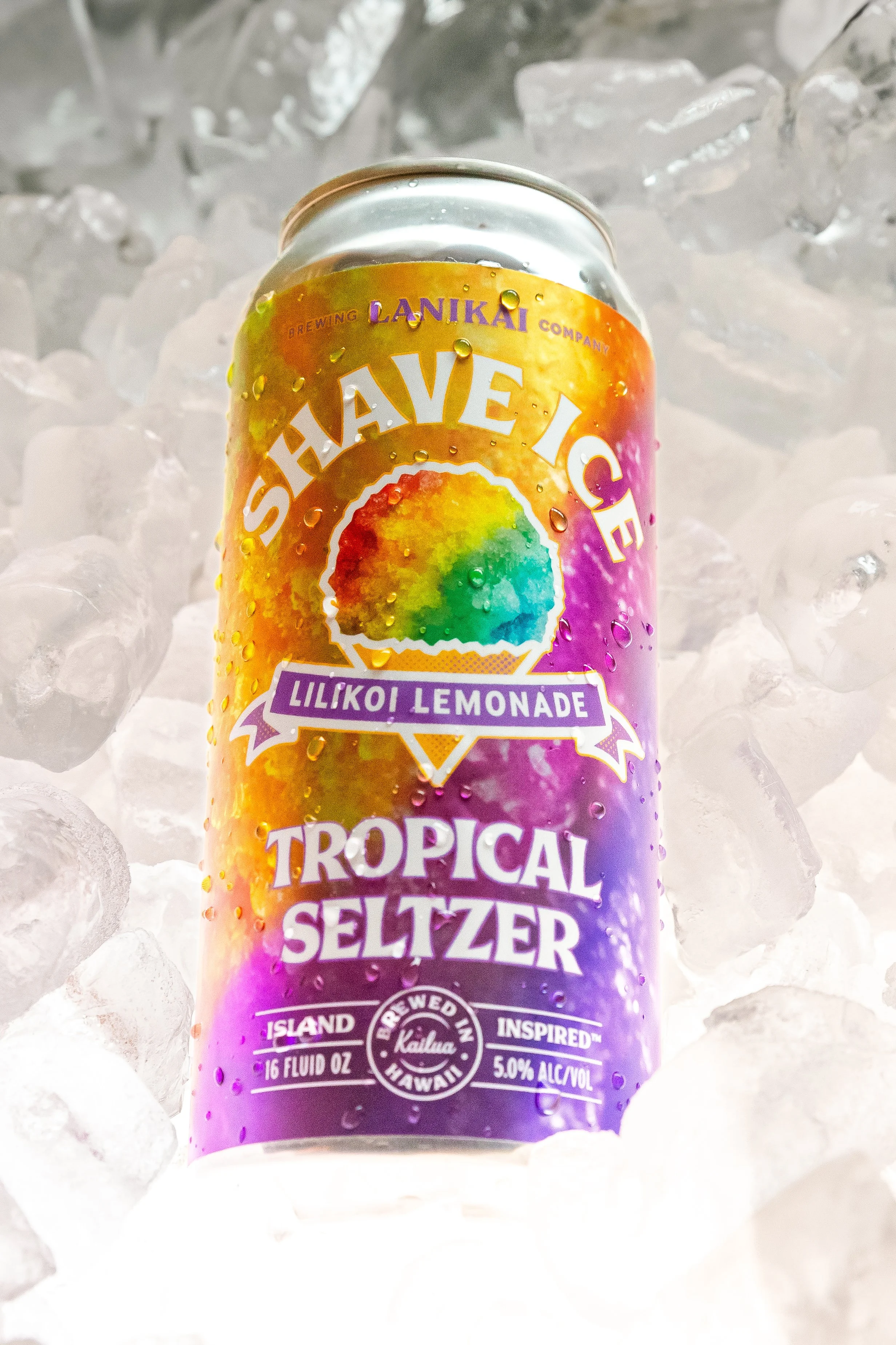 A can of Tropical Seltzer with lilikoi lemonade flavor sitting on ice cubes.