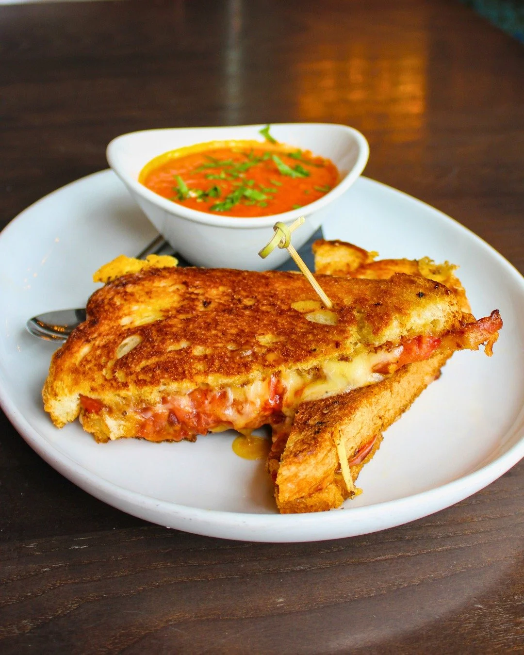 Rainy days call for cozy comfort! ☔ Warm up with our Grilled Cheese paired with a rich Tomato Basil Bisque, the ultimate comfort combo.