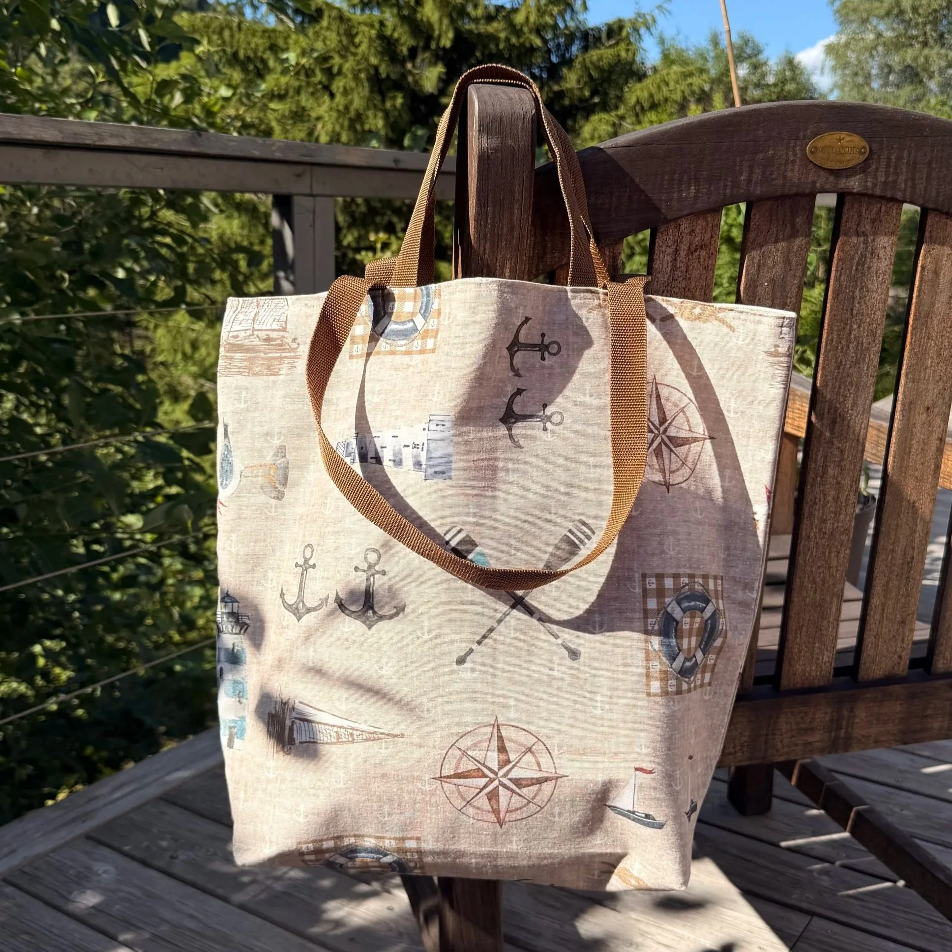 Front view of the Capri summer bag in cappuccino brown with light brown and blue maritime patterns.