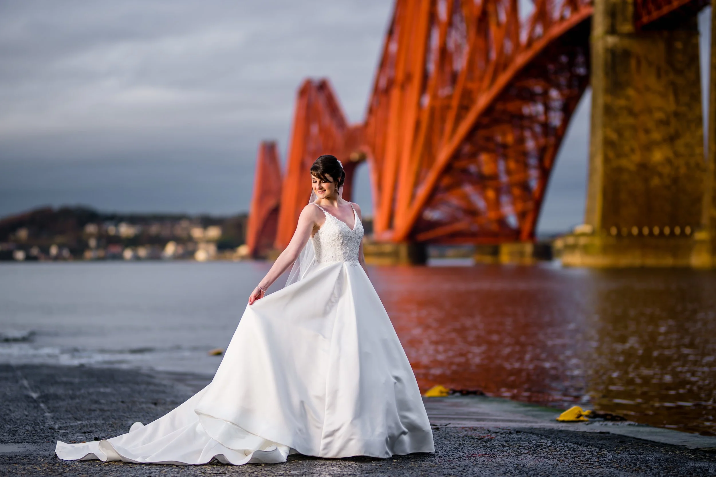 A Bride stands in front of the Forth Rail Bridge, during her wedding in Edinburgh.