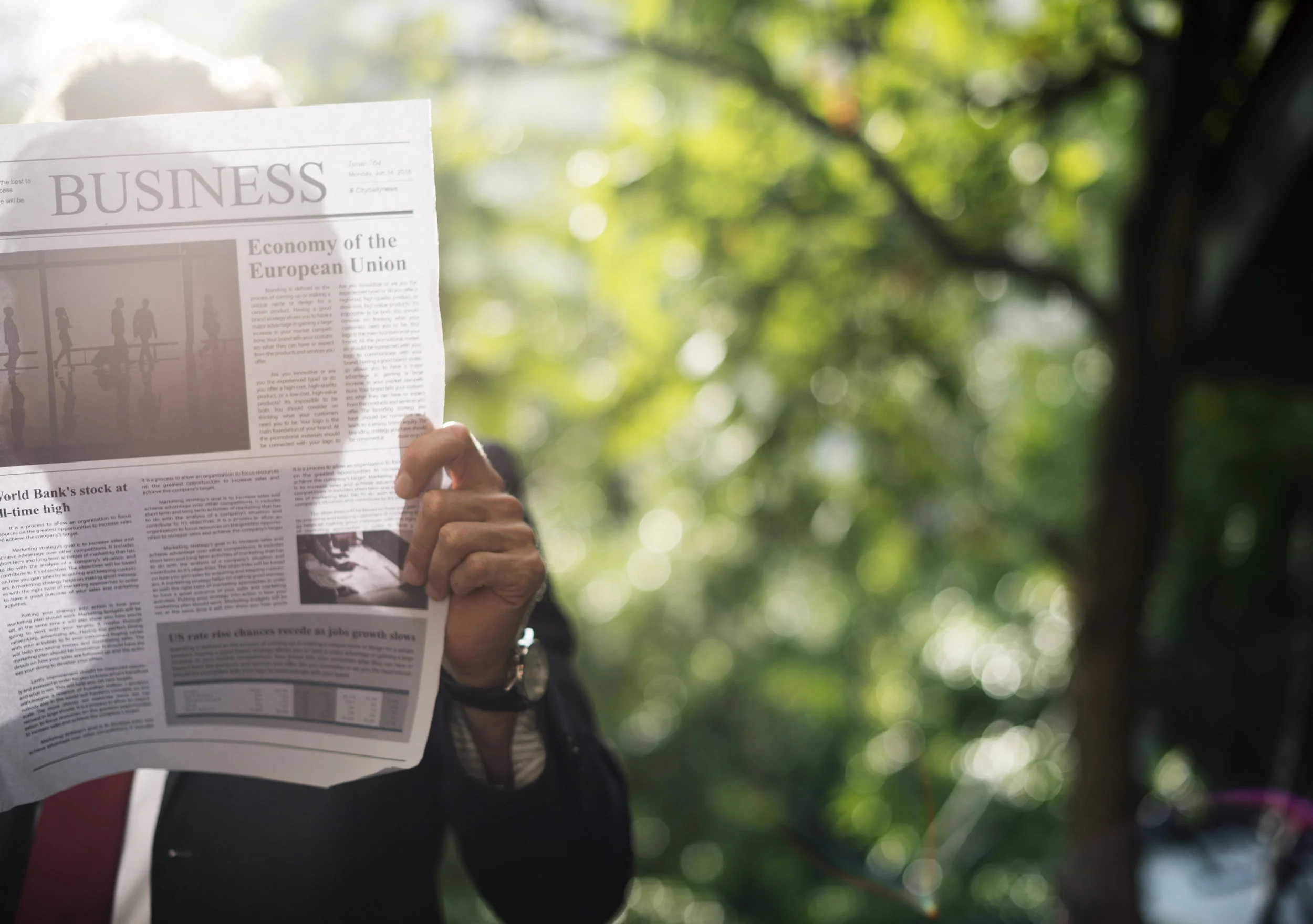 Businessman standing and reading newspaper
