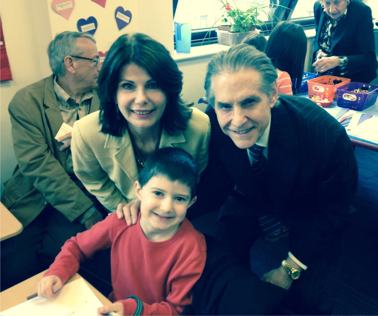 Millie, John, and their grandson at school