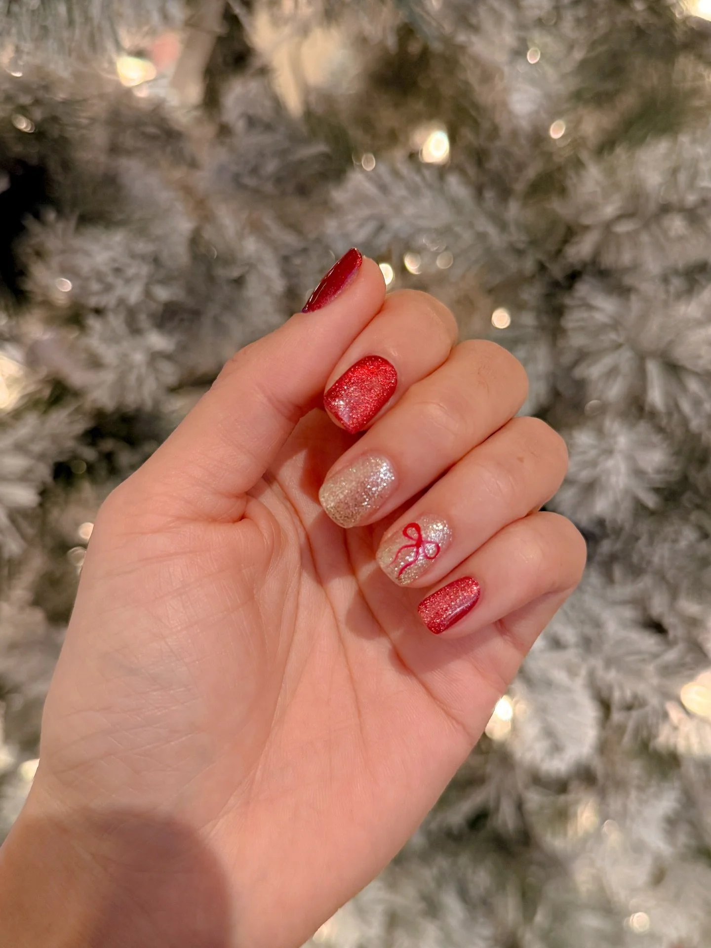Switchover to Christmas nails with premier artist Ivy @lepetitsalon.tustin - I usually don&rsquo;t do color but this red cat eye is gorge and I&rsquo;m obsessed with the painted bow detail #christmasnailsart #christmasnailsart #xmasnails #christmasna