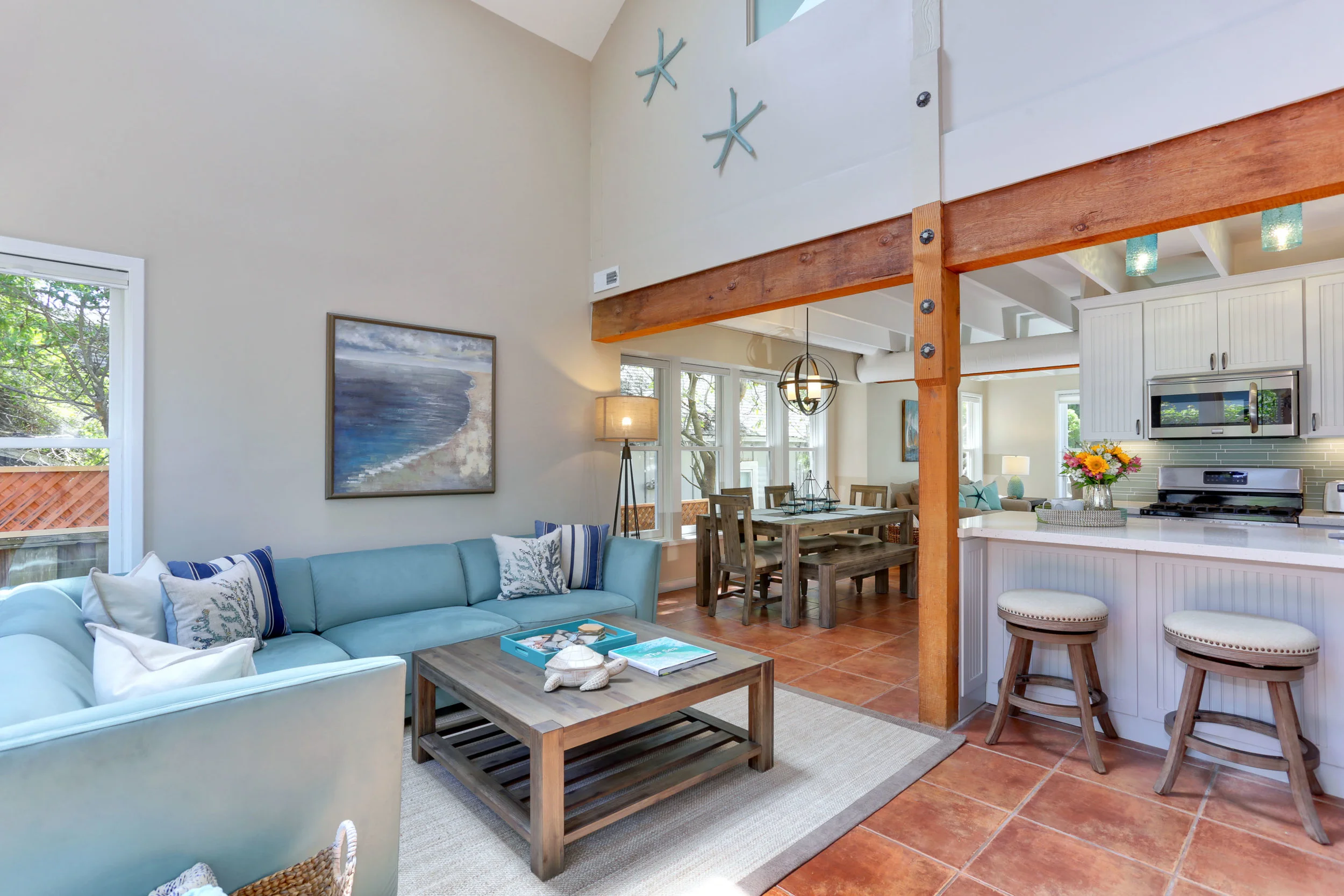 NEW: Updated living room with new furniture and open kitchen unites the various spaces.