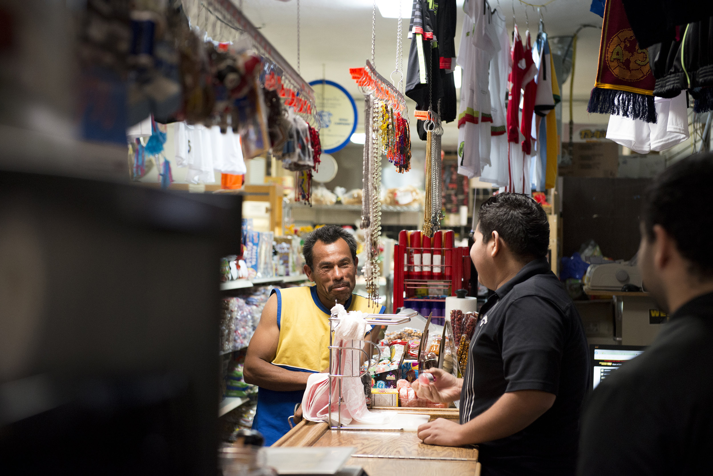 During his nightly visit to El Mercadito in Bowling Green, Ky, José Saldano, an undocument immigrant from El Salvador, greets a counter clerk. Nelson said the only times he leaves his home during a normal week are to buy food at the store, or to wor