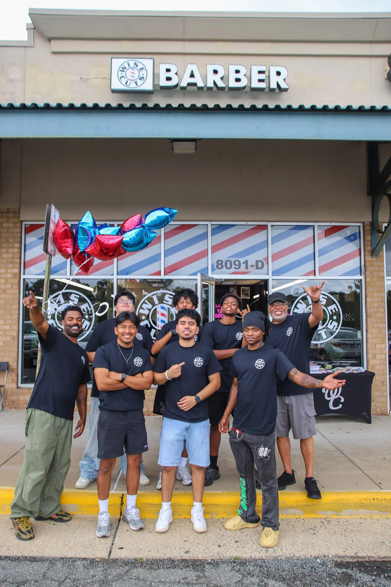 Staff photo from Wisecuts Newington out front of the barber shop