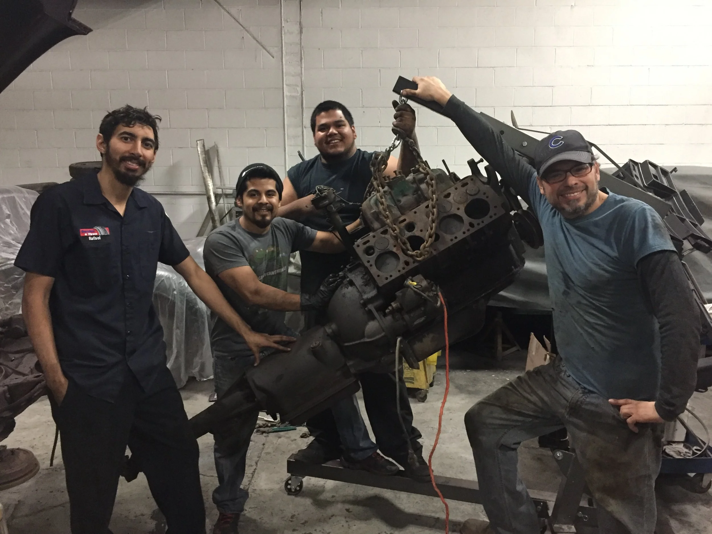 The original Automotive Mentoring Group that started the 1947 Cadillac project posing with the seized original flathead after pulling it from the car. From the left, Rafael Franqui, Edgar Lara, Jesus Gonzalez and Greg Alonzo