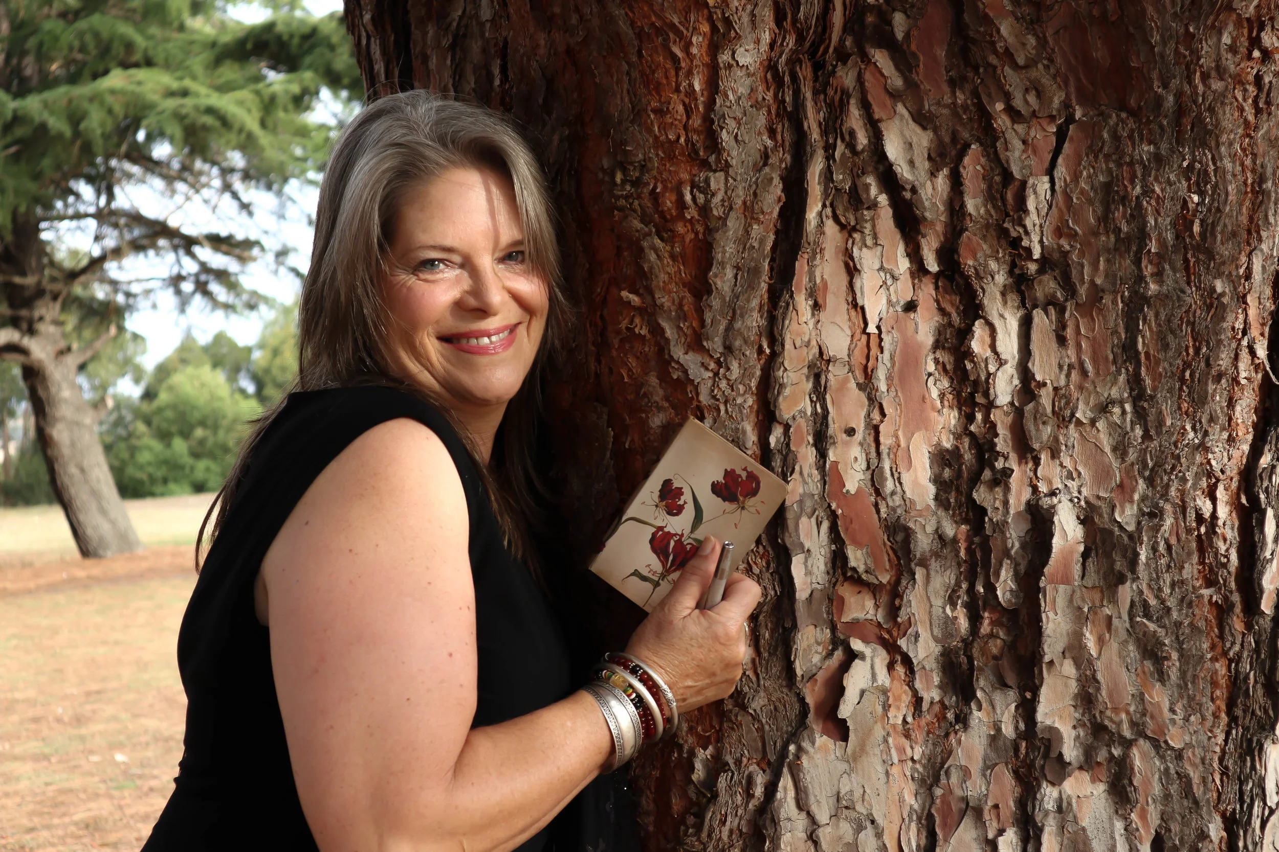Linnet & notebook hugging tree.jpg