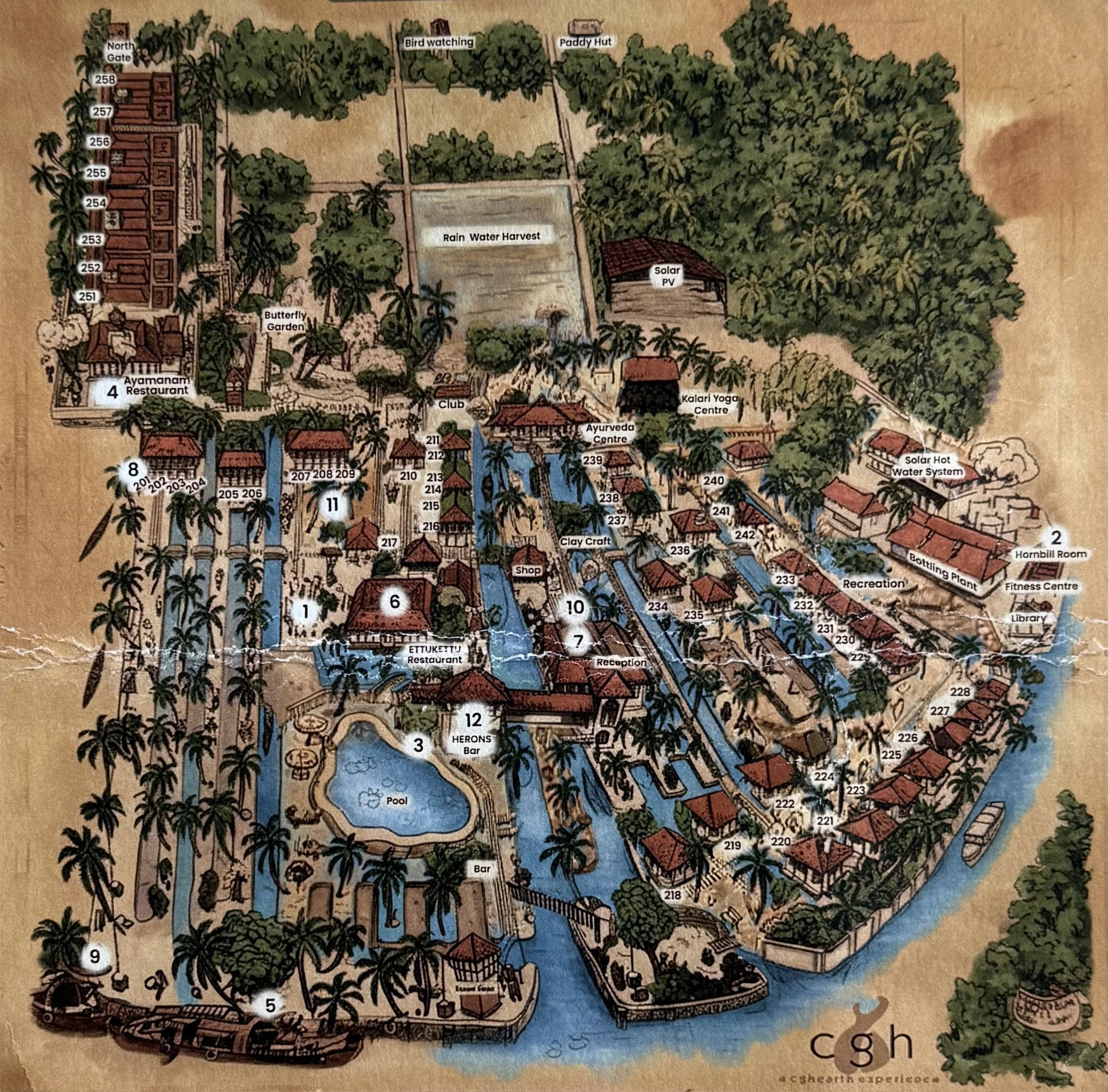Illustrated map of Coconut Lagoon resort in Kerala, showing villas, waterways, restaurants, and gardens.