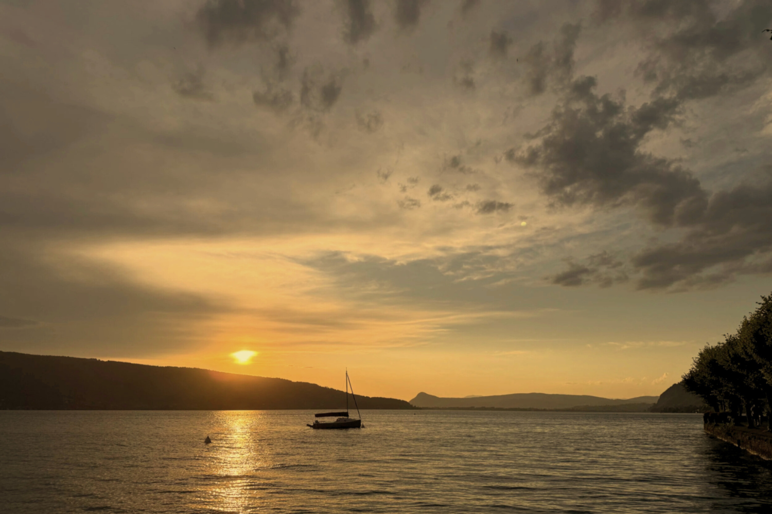 Sunset over water symbolizing mindful, meaningful travel that shifts perspective and sparks creativity.