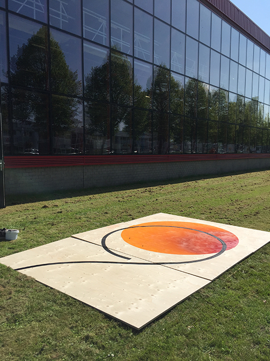 Painting the work outside of the National Opera's decor studio: the spray paint fumes were too heavy for indoor use.