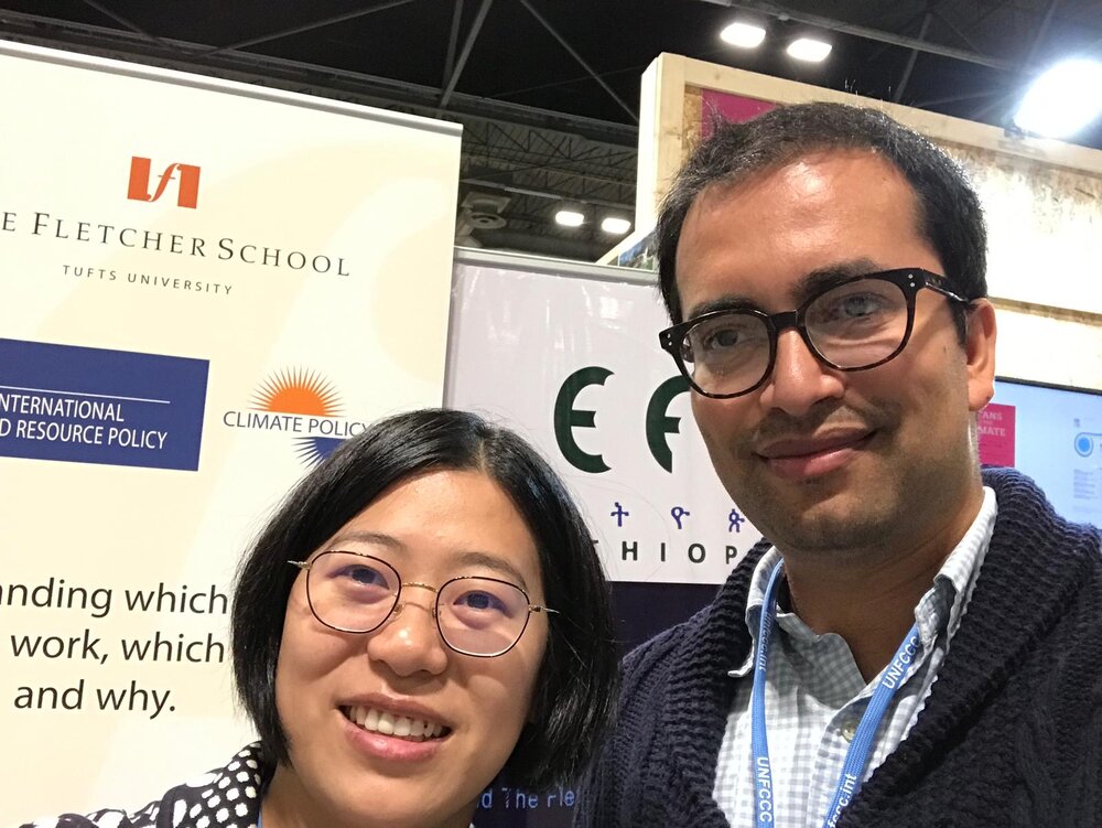 Fang Zhang and Rishikesh Bhandary at the Tufts delegation booth at COP25.