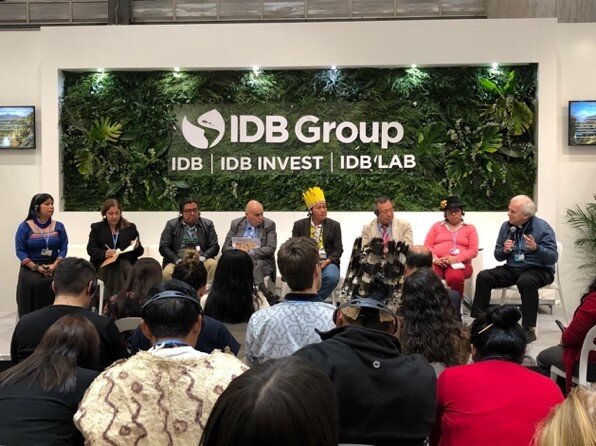 Discussion on development, facilitated by pastor, including representatives of Indigenous Peoples from Amazon Basin at the IDB Group Pavilion.