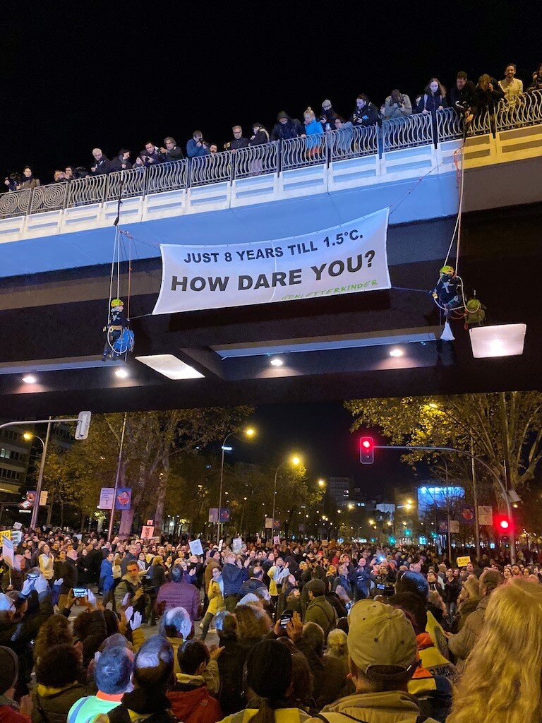 An argument you can’t ignore: children – like the two suspended from this highway overpass during the Climate March in Madrid – are furious that they will inherit a world irreversibly impacted by climate change, especially if we continue on the projected path.