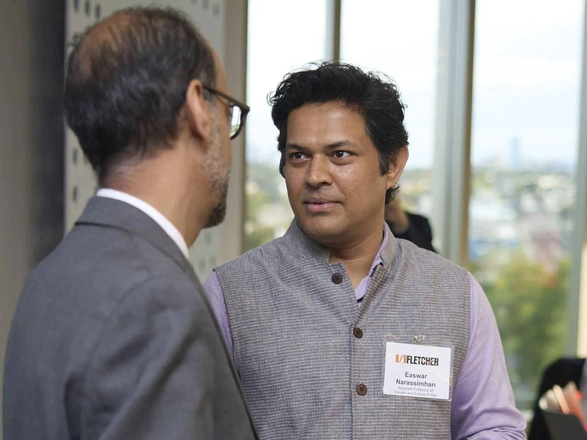 two people speaking informally in a conference setting