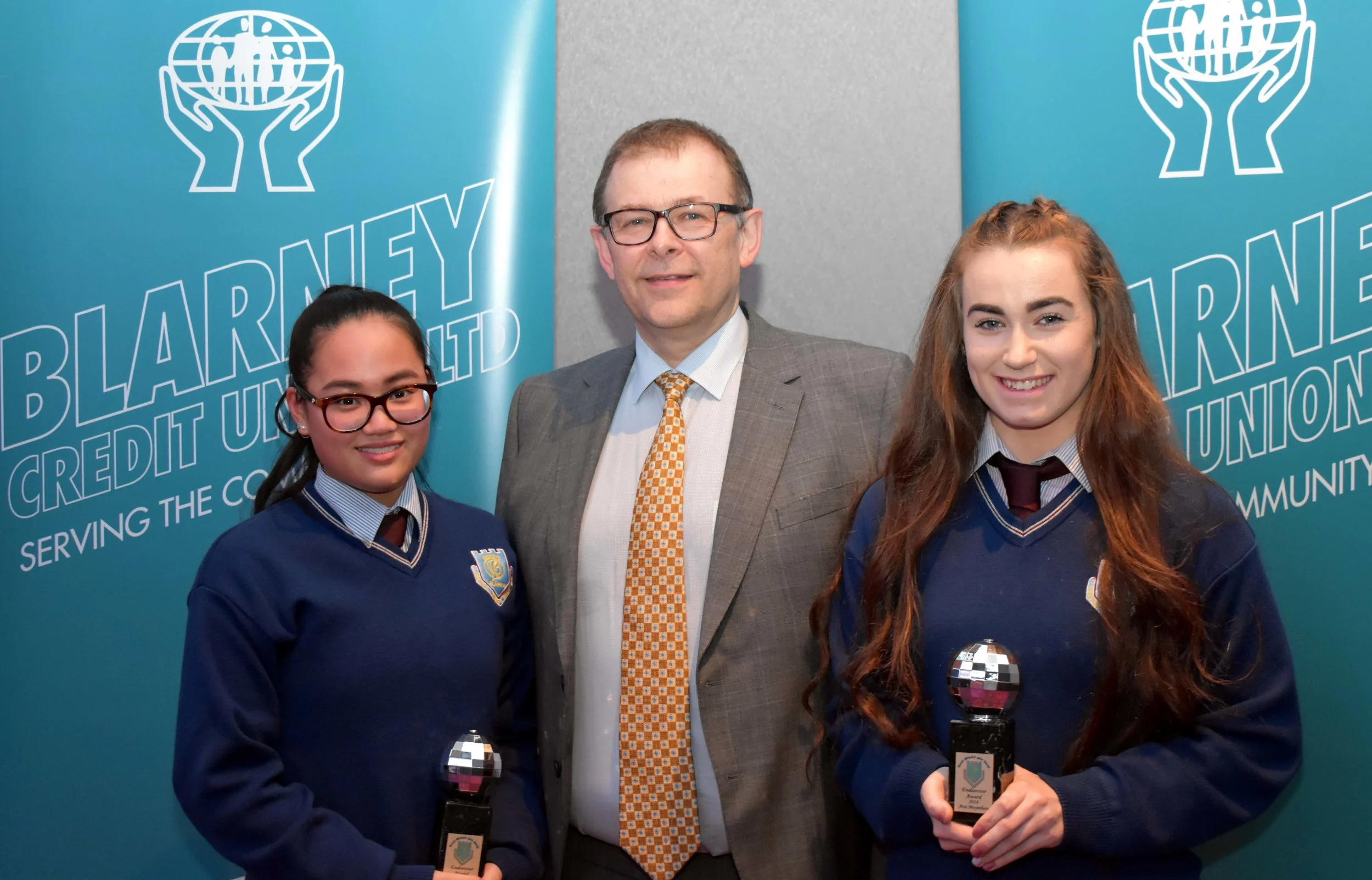Luci Kelleher and Ava Moynihan receiving an endeavour award for representing Ireland in the Dance World Cup in Barcelona. (Pictured with Mr. Mark McGloughlin - BOM and Blarney Credit Union)
