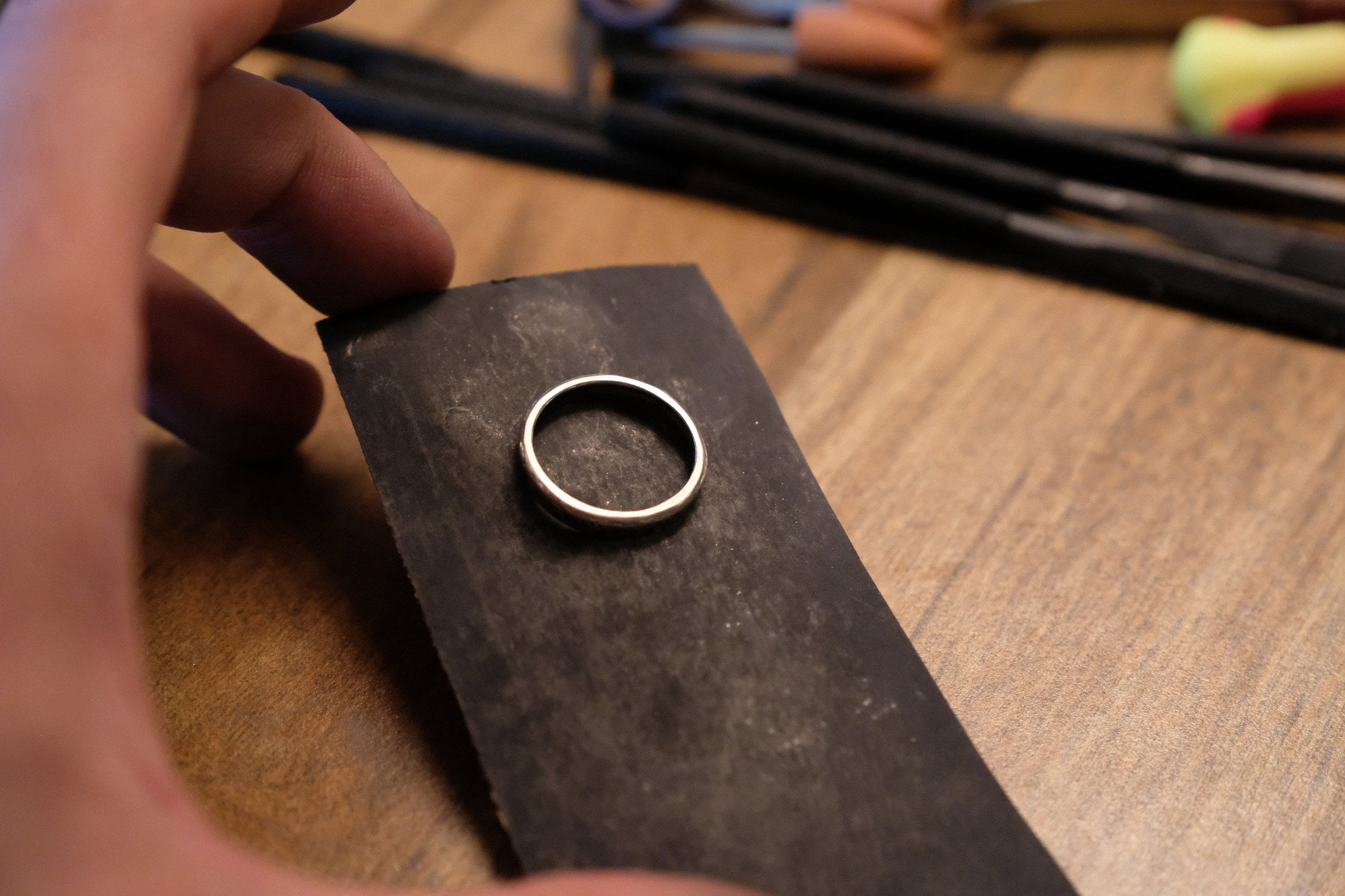  The ring is sanded with 400, 600, 800, 1000, 1200, and finally 1500 grit sandpaper. This takes off surface scratches and small imperfections.&nbsp; 