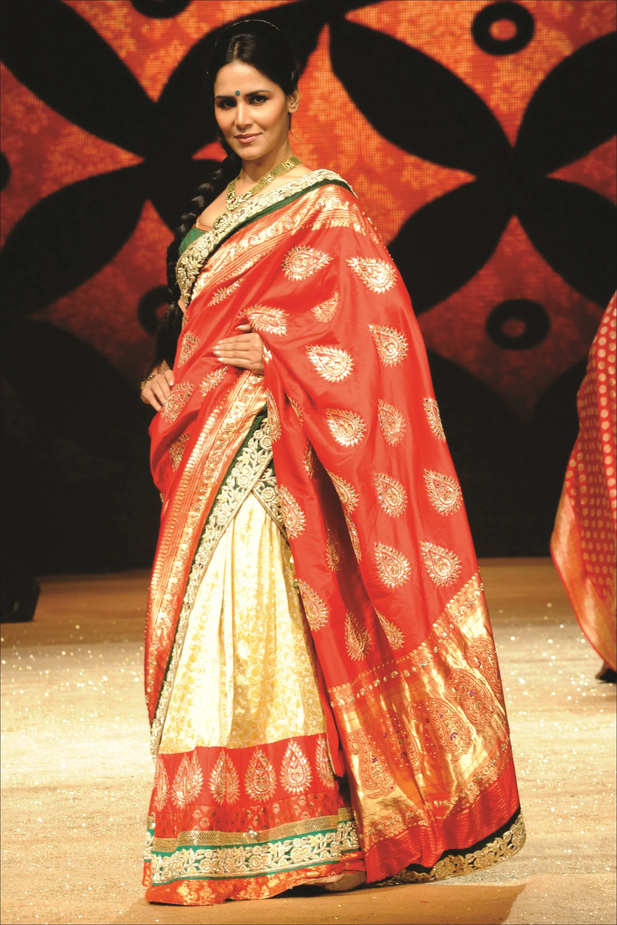 Lehnga Saree from Shyamal Bhumika in traditional red and gold colors
