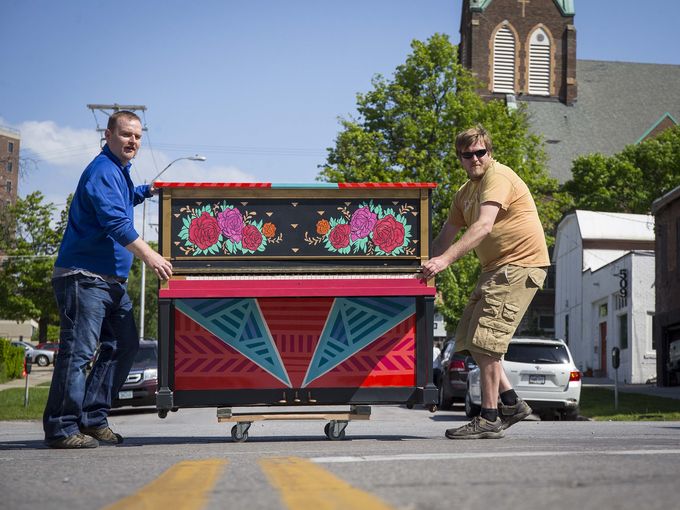 West Music's Jeff Weimar and Tony Grimm, right, roll a piano up Grand Ave. in the East Village for City Sounds: Des Moines Public Piano Project Thursday May 19, 2016. Photo by Rodney White / The Register.