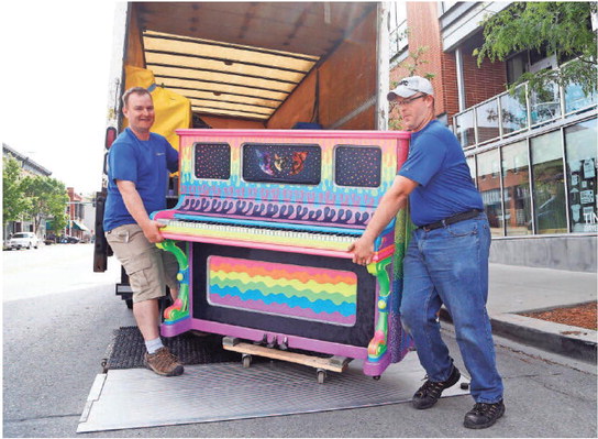 Jeff Weimar (left) and Adam Miller with West Music unload the first of 10 pianos they are placing around downtown Des Moines on Tuesday outside of RAYGUN in the East Village. The pianos were installed as part of City Sounds’ annual public piano project, and will be in place through late September.