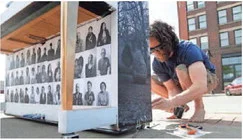 Ryan O’Mara, a board member with City Sounds, anchors a piano in place Tuesday on the corner of Court Avenue and Water Street. Each piano was decorated by different Iowa artists.