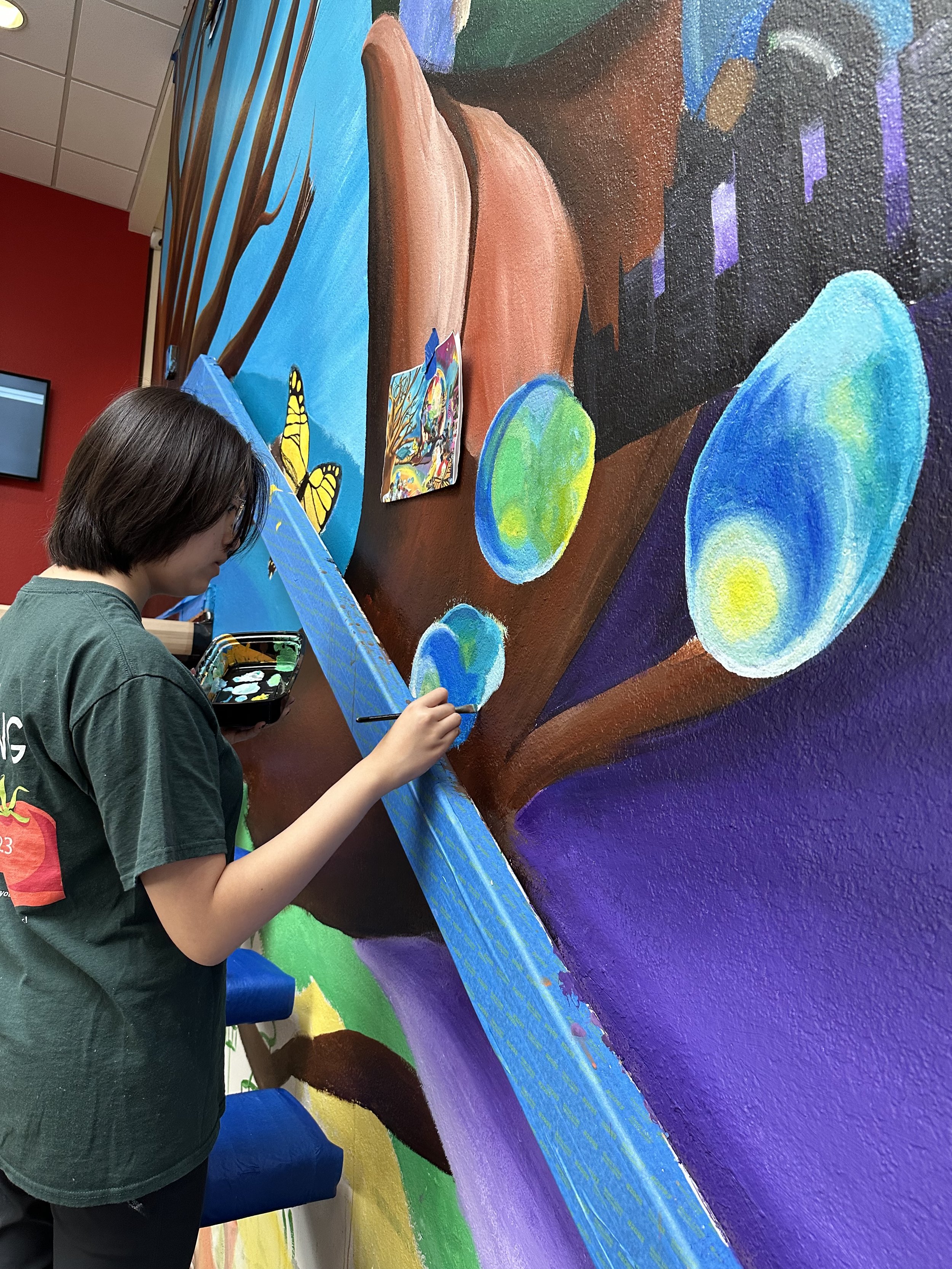 student painting mural at san mateo.jpg