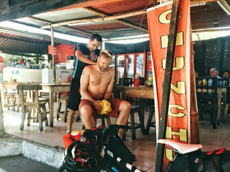 Omar is trying to fix my neck at a truck stop.