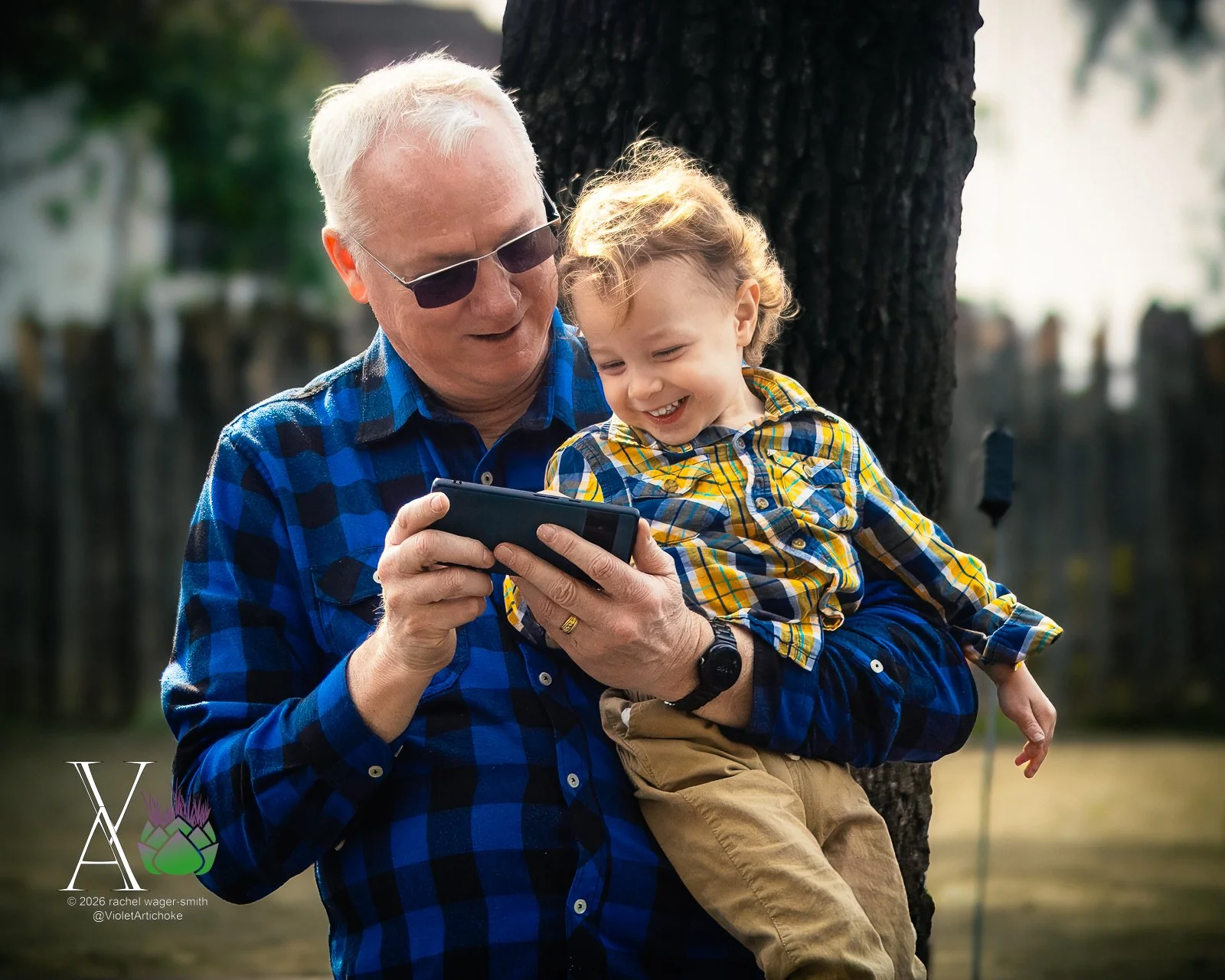 Man and Boy Laugh at Phone