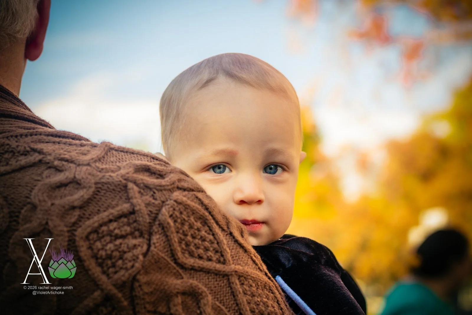 Young Boy Held By Man