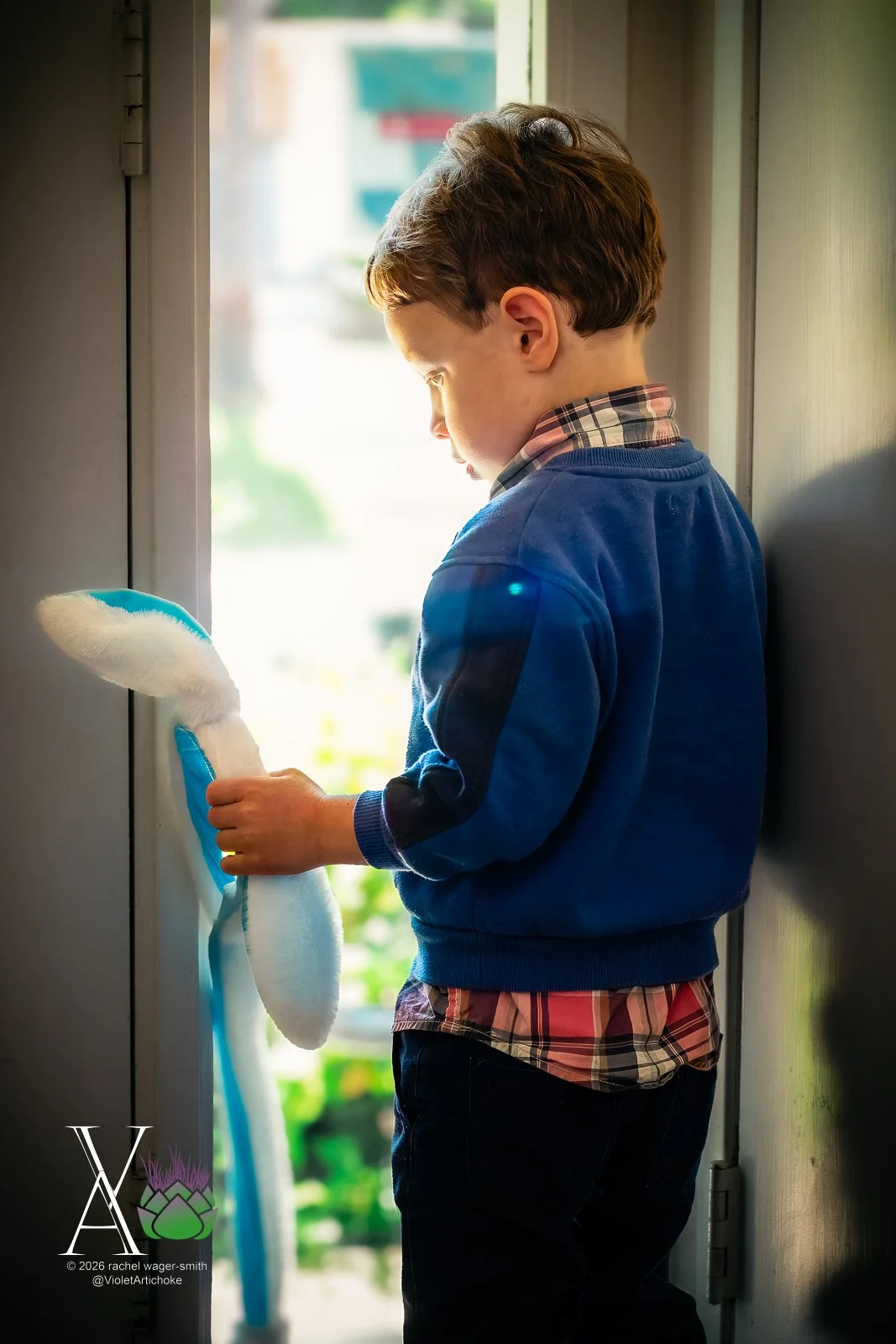 Young Boy Looks Out Window
