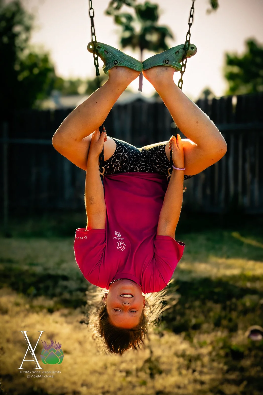 Girl Hangs Upside Down on Swing