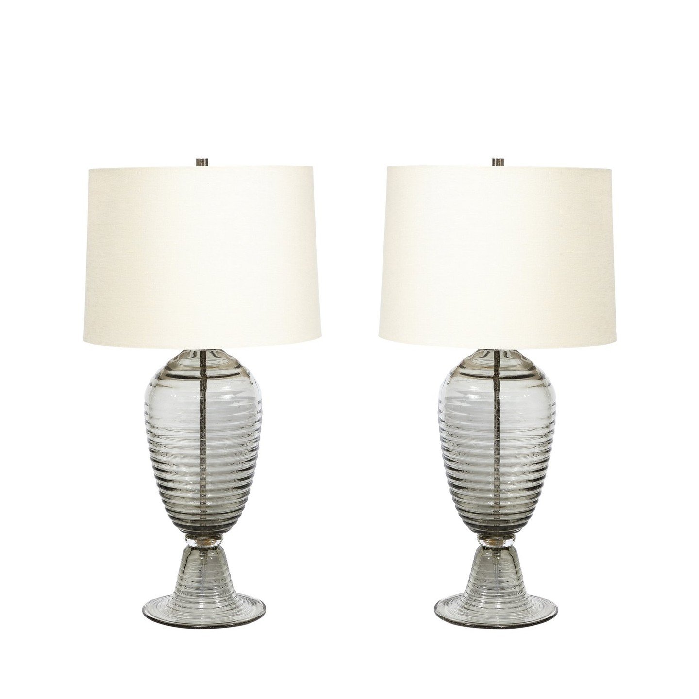 Modernist Art Deco Style Hive Form Hand-Blown Murano Smoked Glass Table Lamps

This pair of Modernist Hive Form Hand-Blown Murano Smoked Glass Table Lamps originates from Italy during the 21st Century. Featuring a beautiful profile with horizontal gr