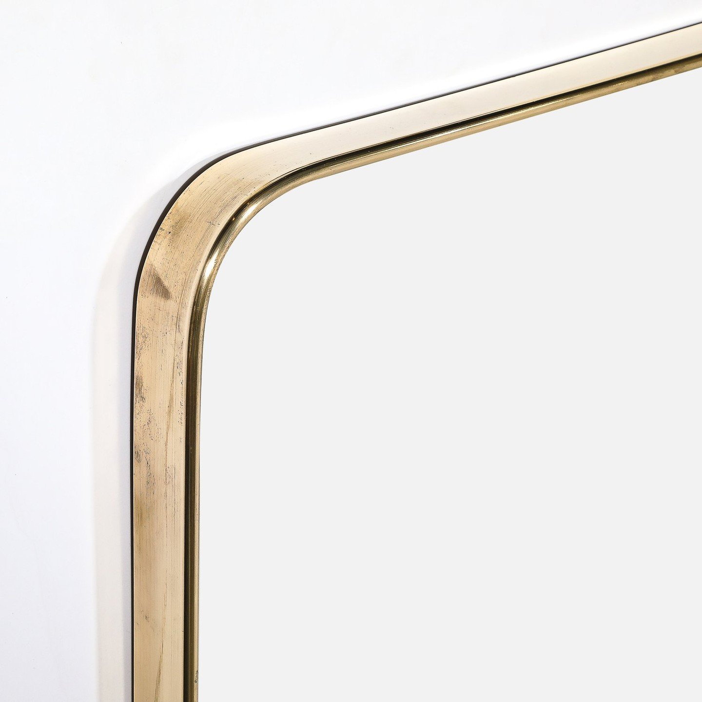 Mid-Century Modernist Rectangular Brass Wrapped Mirror

This beautiful Mid-Century Modernist Rectangular Brass Wrapped Mirror originates from Italy, Circa 1960. It features a rectangular form with subtly rounded shoulders. The lustrous brass frame hu