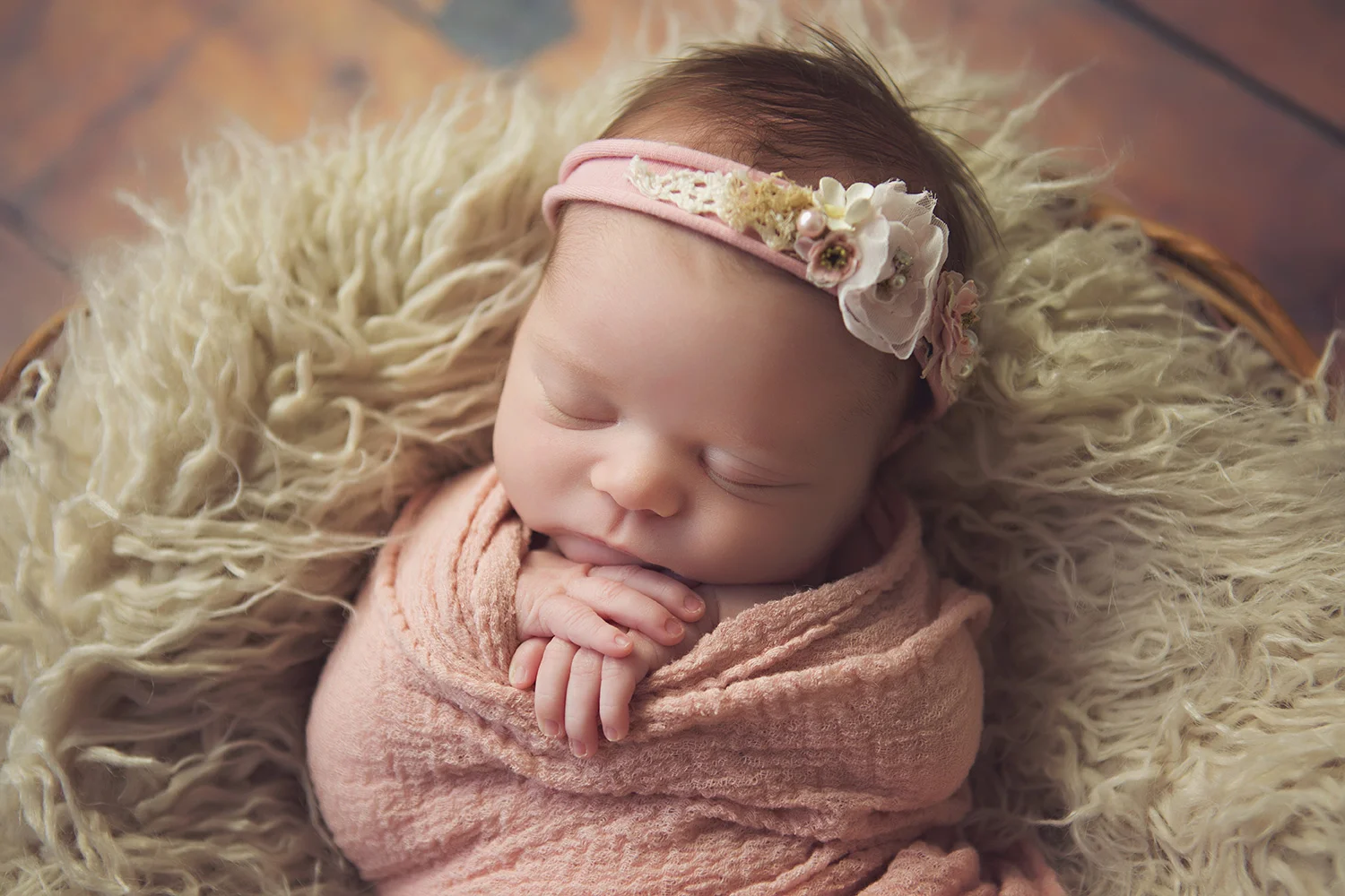 Newborn baby girl in a pink blanket