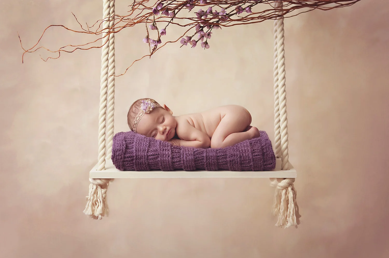 Sleeping baby girl on swing