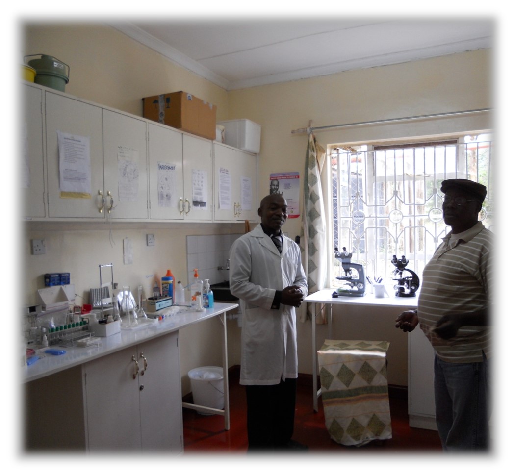 Muthoka with a lab tech in the Clinic Lab