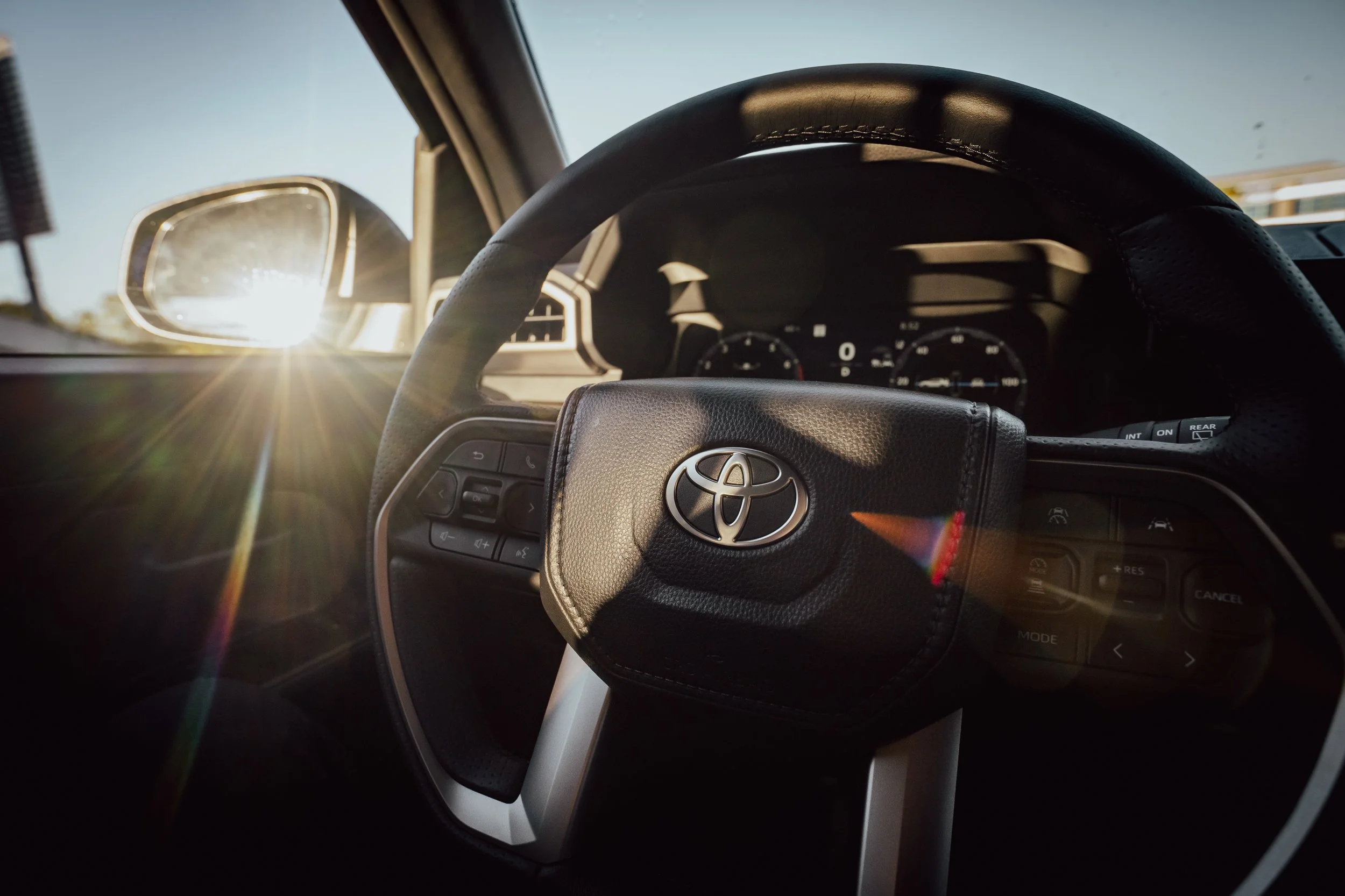 POV interior shot of a 2025 Toyota 4Runner TRD Sport with steering wheel and dashboard in frame, sunlight streaming through the windshield, captured on Sony a1 with the Tamron 16-30mm f/2.8 G2 by Pittsburgh photographer Ian Jones.
