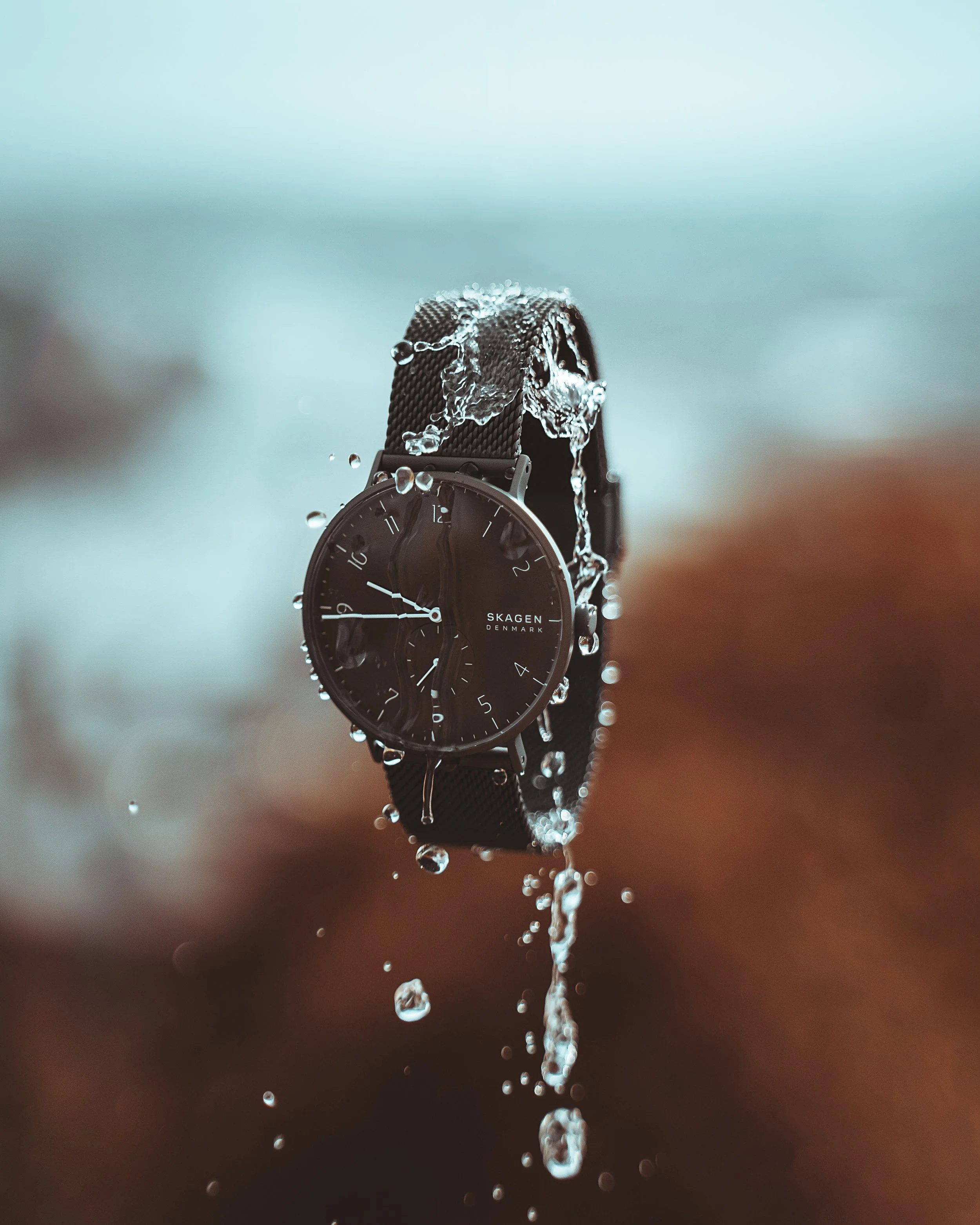 High-end creative product photography of a men’s fashion watch floating in mid-air, captured by Ian Jones for ISJDesigns