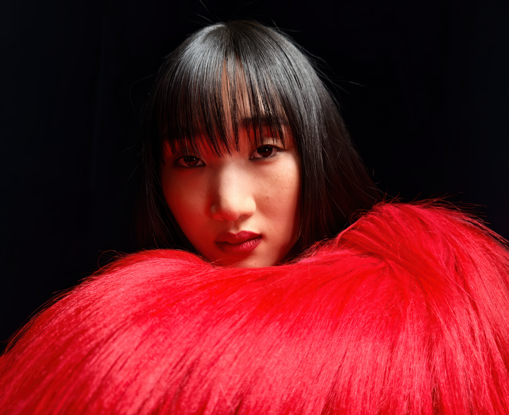 Apple-supplied iPhone 17 Pro 48MP sample portrait showing a subject in textured red fur, demonstrating fine detail, skin rendering, color separation, and controlled depth in portrait photography.