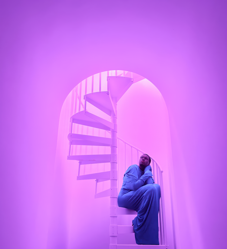 Apple-supplied iPhone 17 Pro Night mode sample photo of a spiral staircase, showing low-light exposure control, highlight retention, shadow detail, and repeating architectural lines.