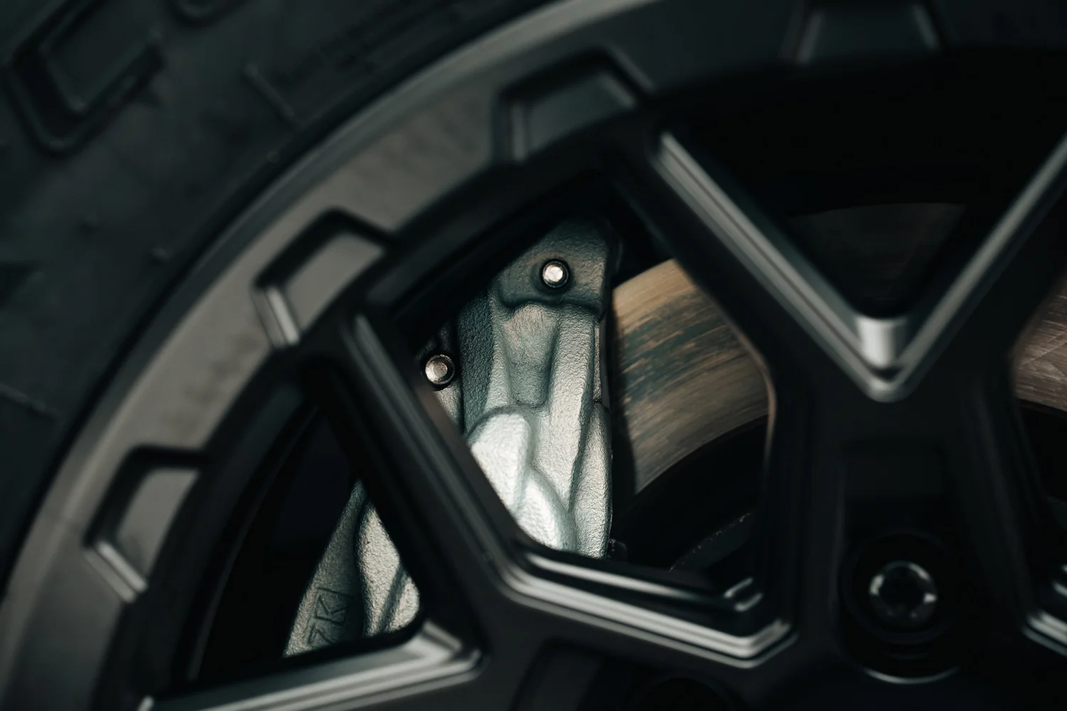 Brake caliper and rotor detail framed by a black Rocktrix wheel, Ian Jones Pittsburgh automotive product photography by ISJDESIGNS