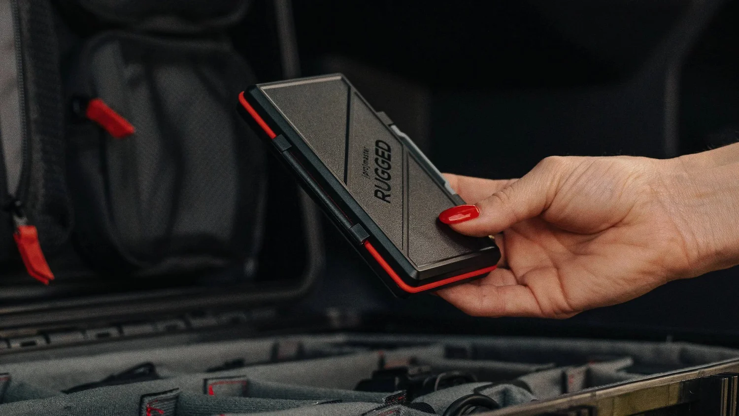 ProMaster Rugged memory card case held over an open gear case, compact scale shown. Ian Jones, ISJDESIGNS.