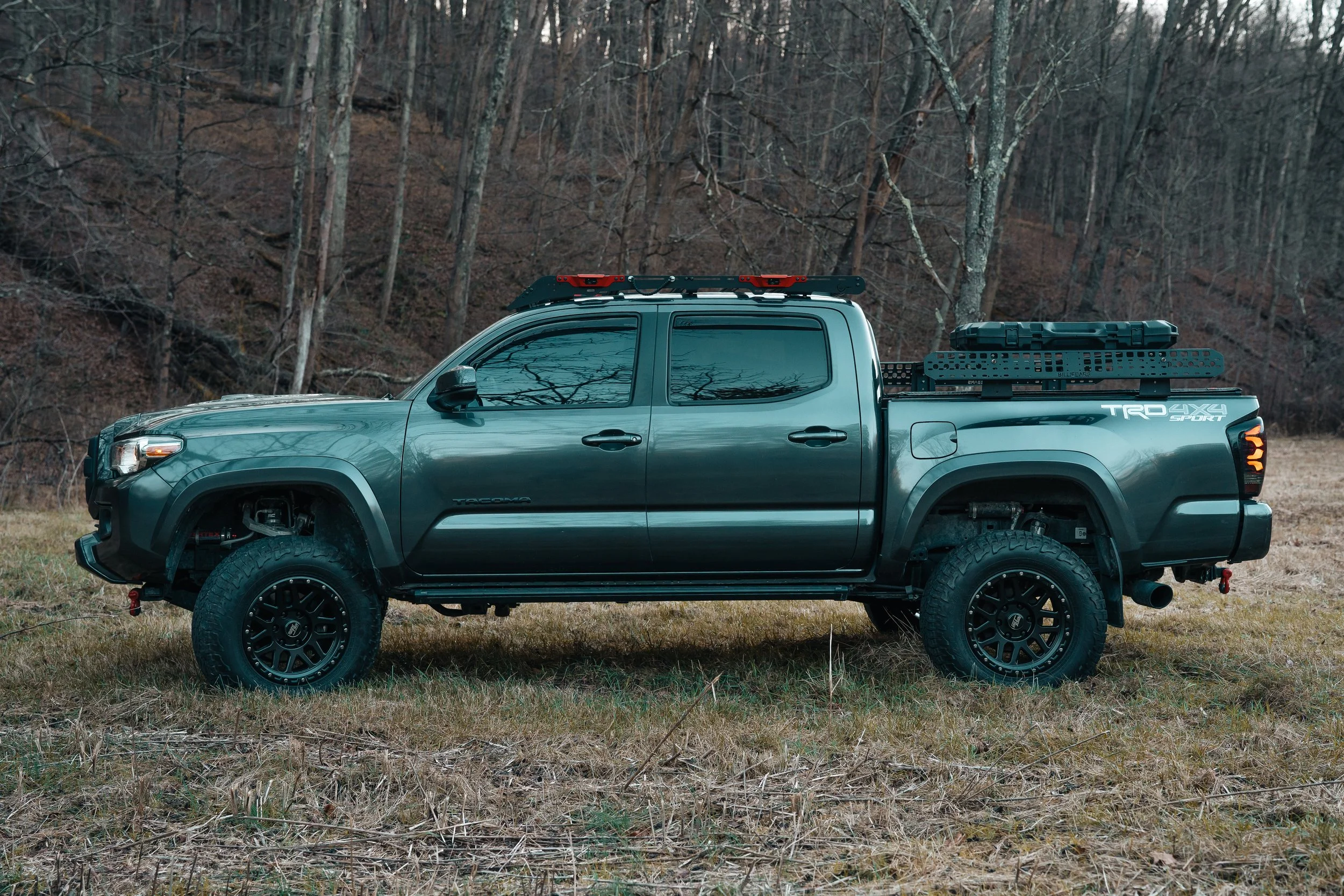 Side view of a 2019 Toyota Tacoma TRD Sport featuring RockTrix Classic Seven split-spoke mesh wheels and Falken WildPeak AT3W 265/70R17 tires, shot off-road for durability and style, photographed by Ian Jones for ISJDESIGNS.
