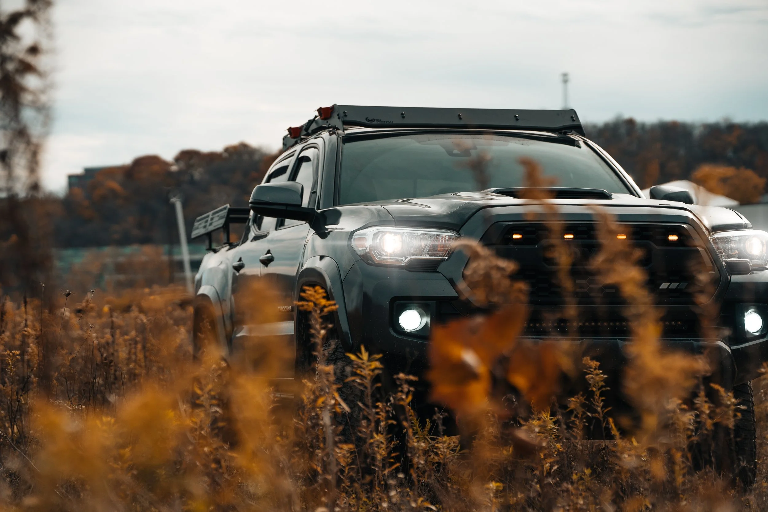 Front view of a 2019 Toyota Tacoma TRD Sport featuring a TRD Pro grille, shot off-road for rugged style and performance, photographed by Ian Jones for ISJDESIGNS.