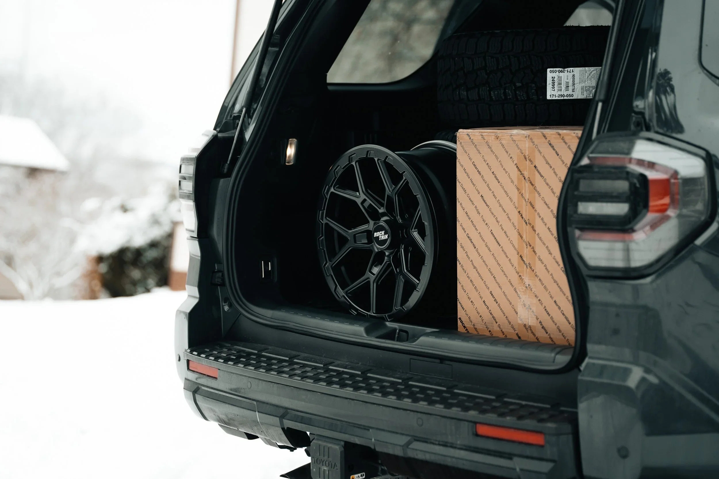 RockTrix wheel in the cargo area of a 2025 Toyota 4Runner TRD Sport with RockTrix shipping box