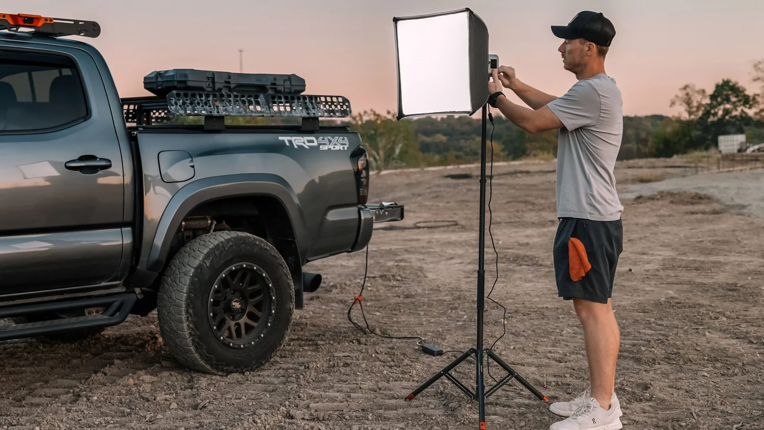 Ian Jones using portable lighting next to Toyota Tacoma mobile studio setup on location in Western PA