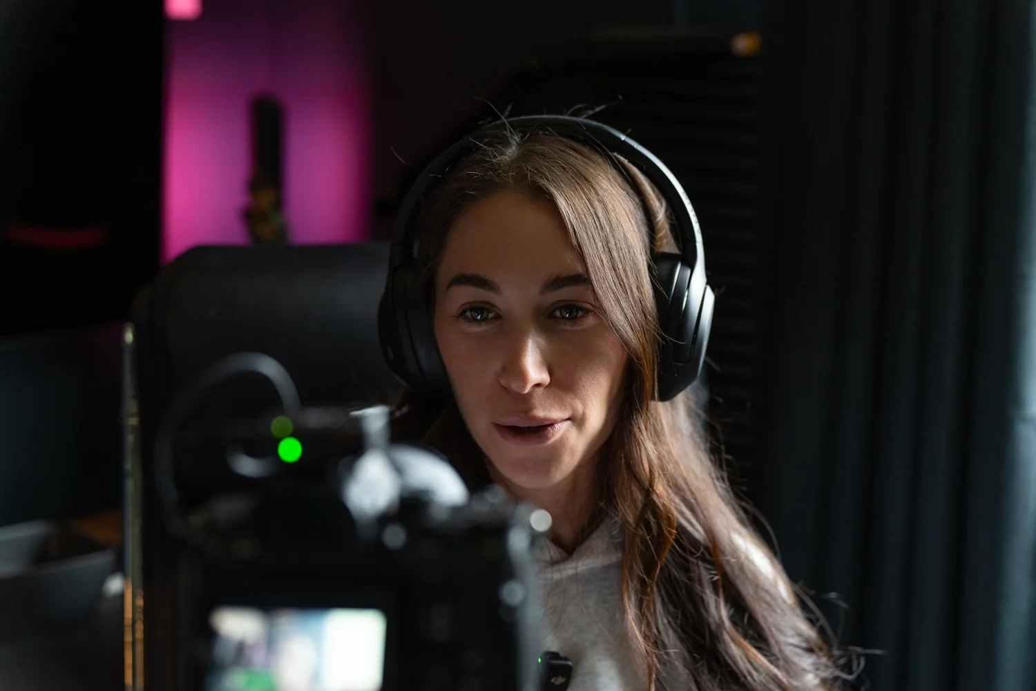 Creator recording video in Ian Jones' Pittsburgh studio with camera and headphones