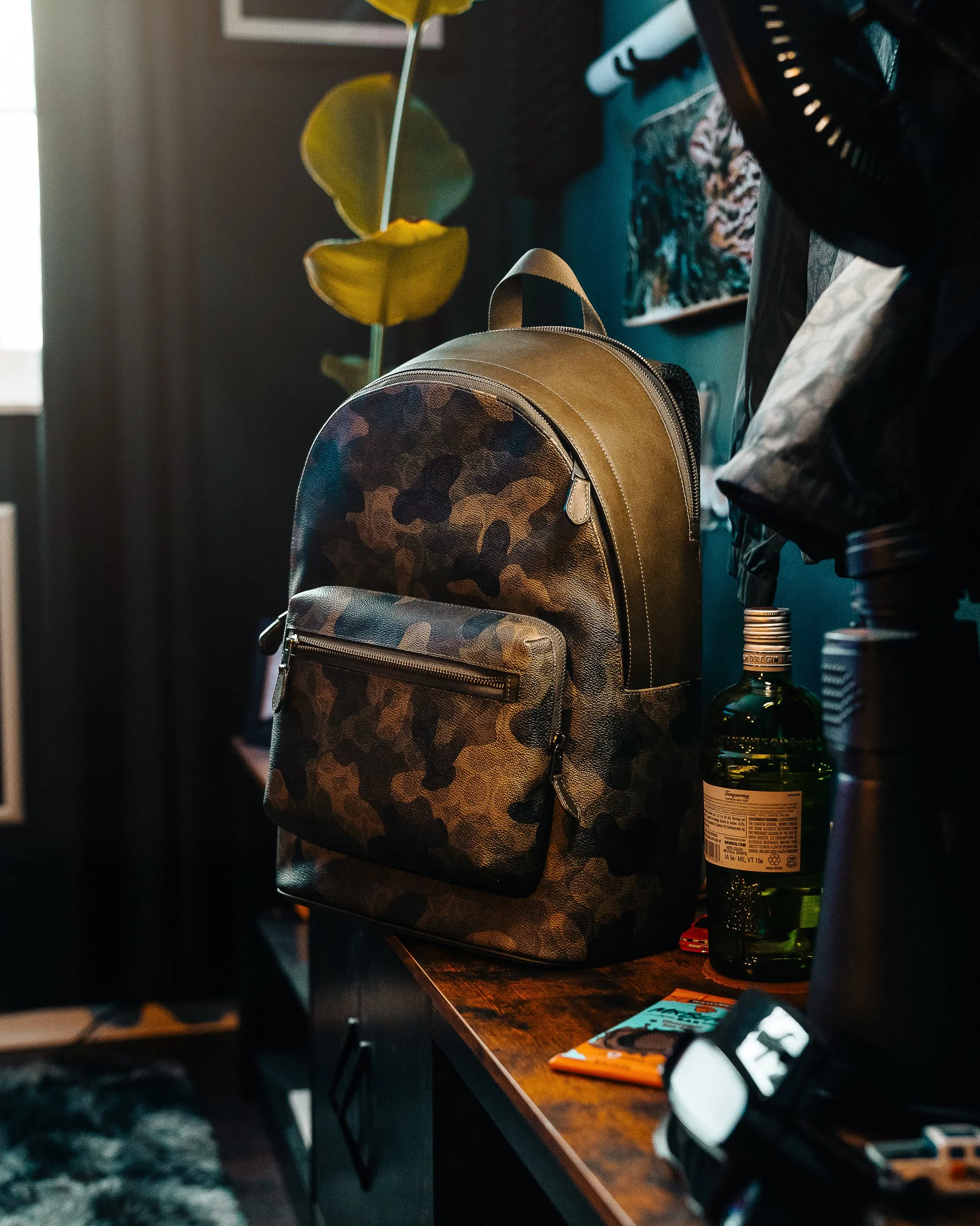 Coach West Backpack in Signature Camo Print photographed by Ian Jones inside his home studio office with professional lighting for ISJDesigns